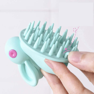 Soft Rubber Shampoo Brush for Kids' Scalp Massage in hand, showing bristles for gentle washing during bath time.